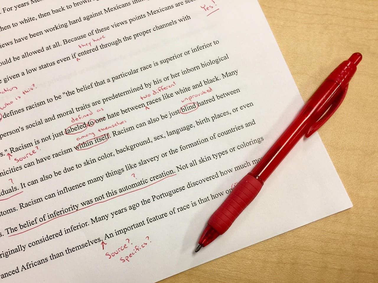 Document being marked up with a red pen during an editing pass