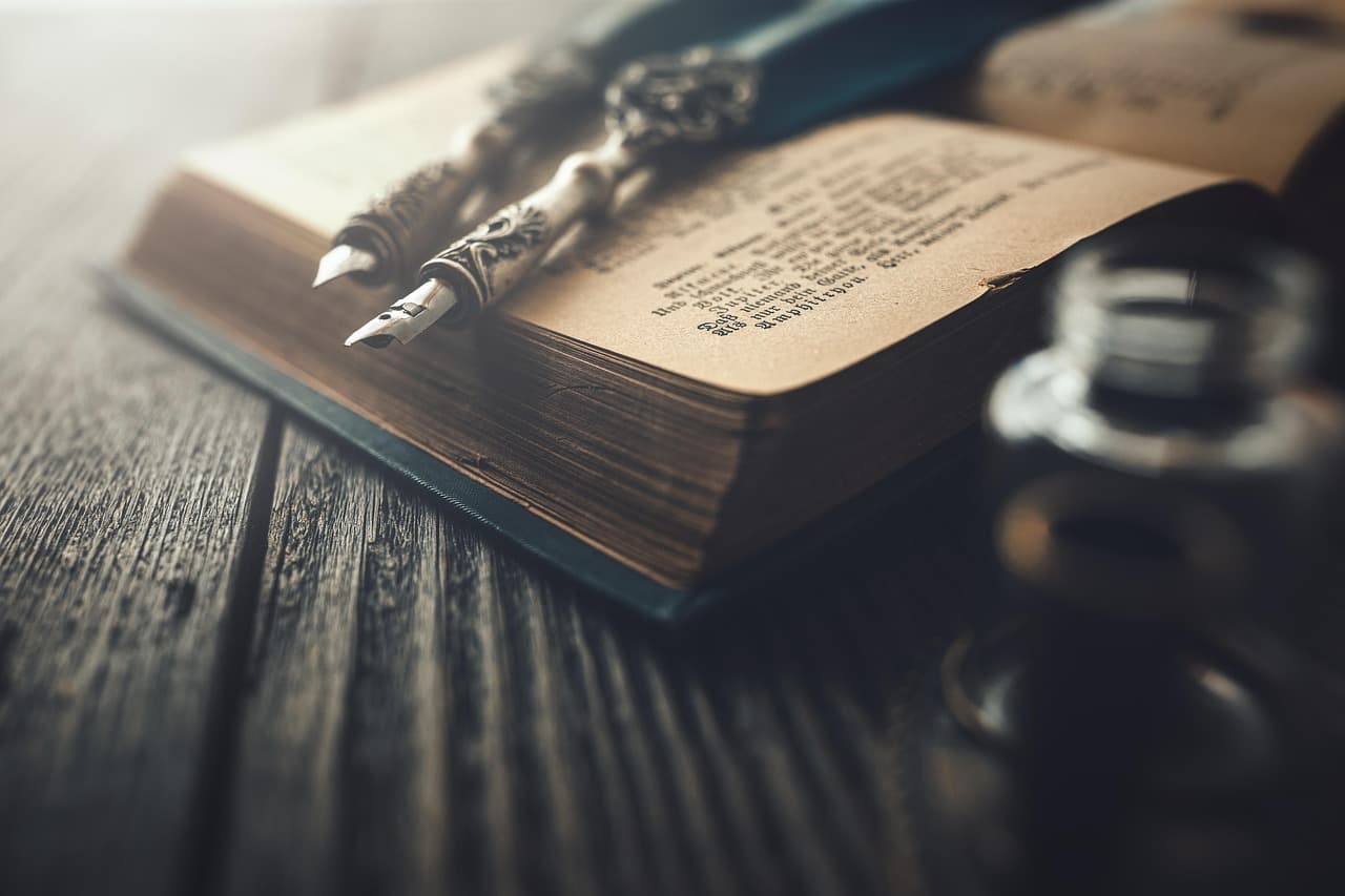 Close-up of a red pen marking edits on a printed manuscript page